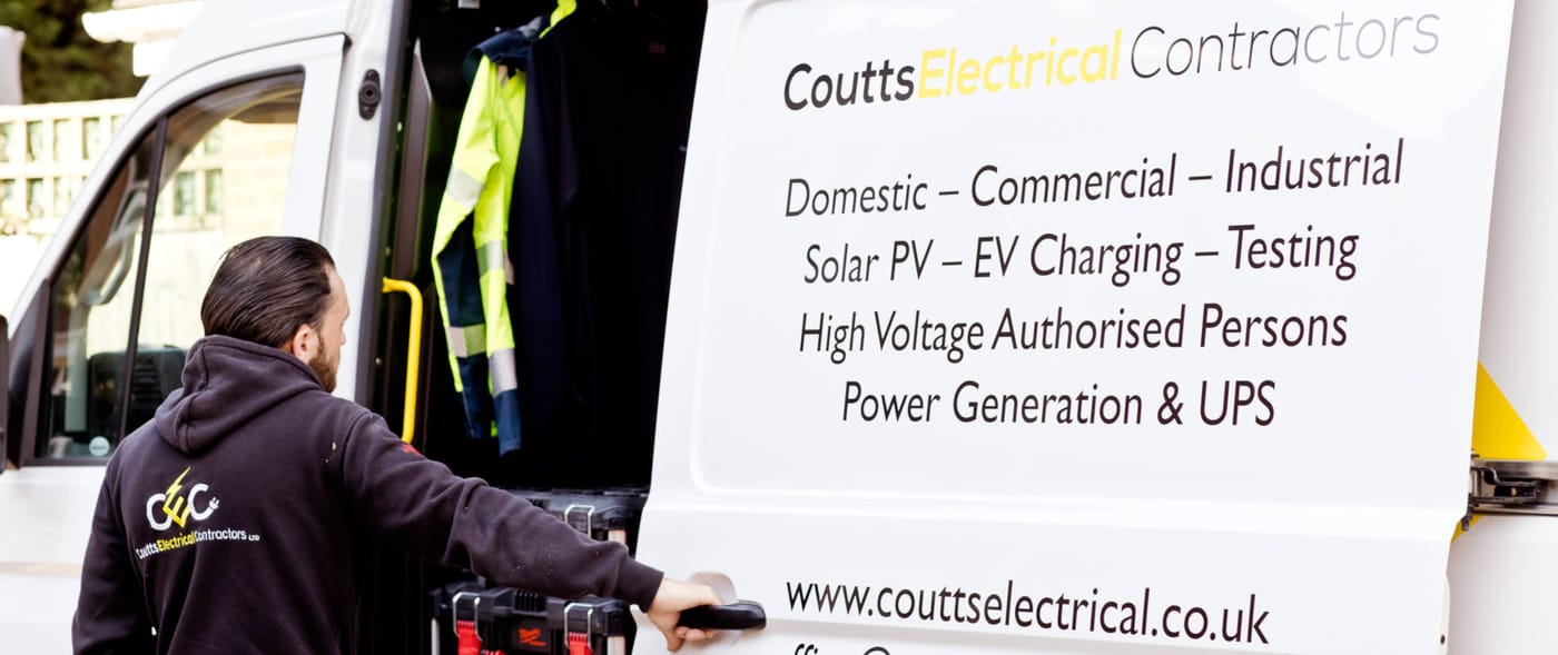 A Coutts Electrical Contractors engineer at the side of the company's liveried van