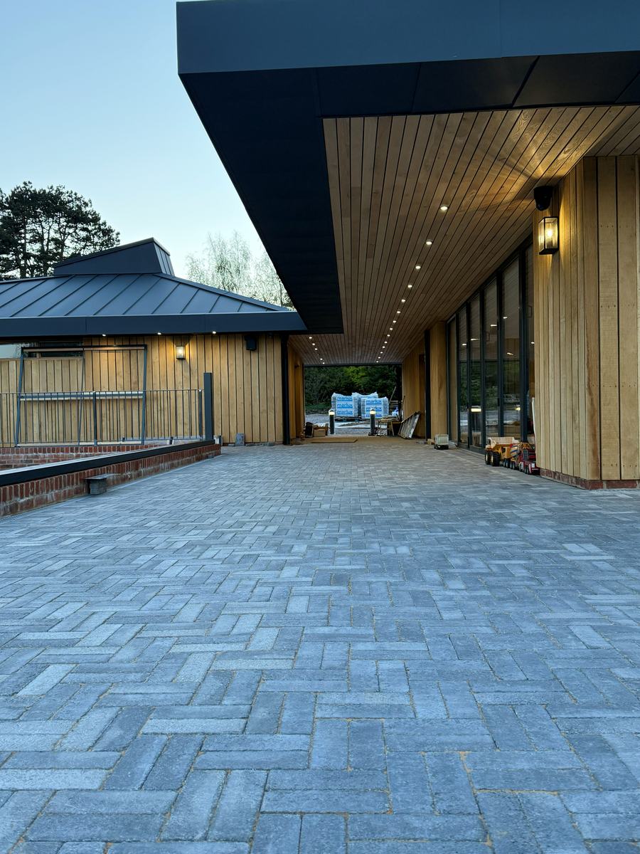 The lit colonnade and block-paved approach to Dragonfly Farm Shop & Café in Speldhurst — photograph 24 of 25