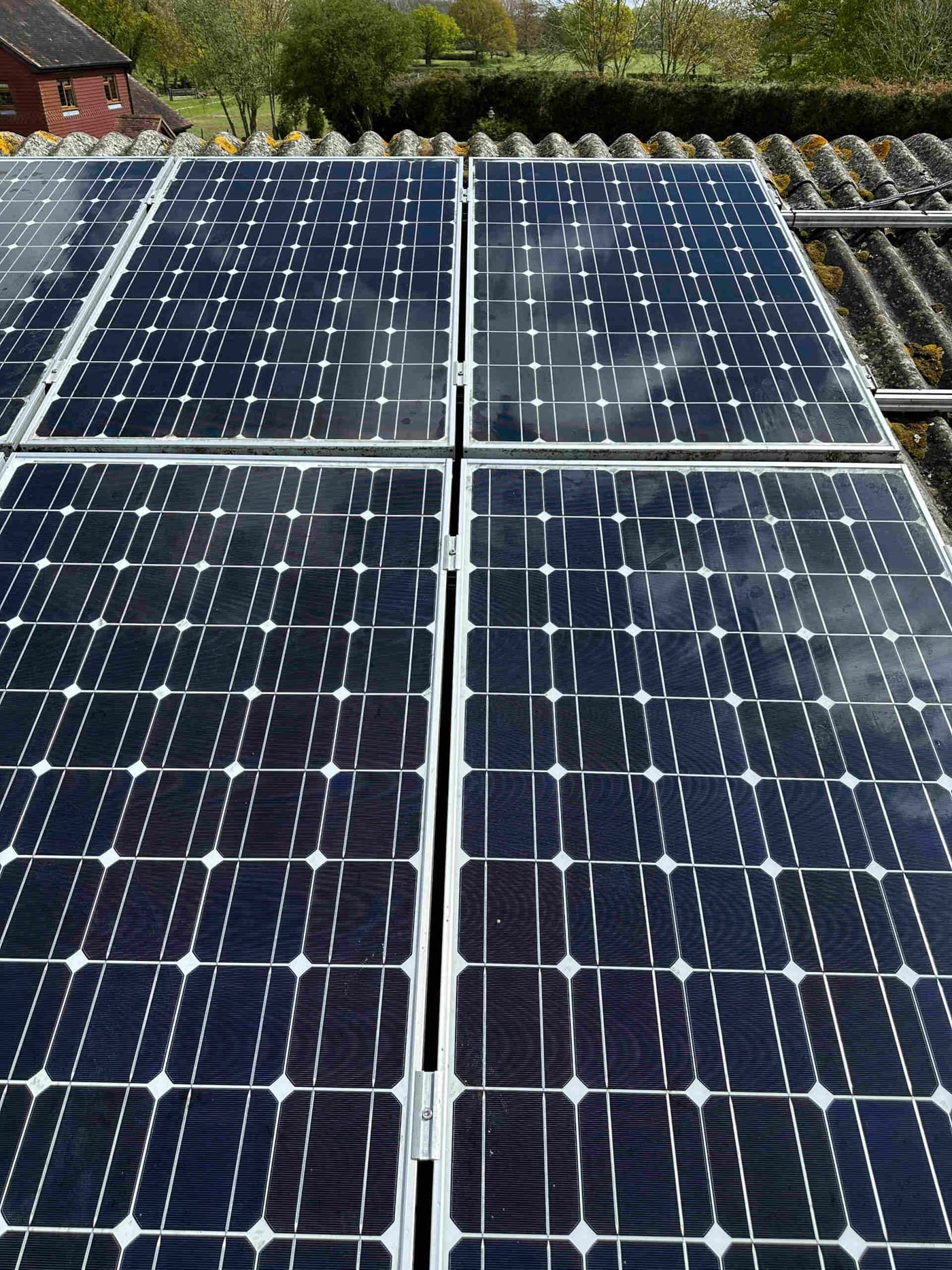 A close view of a roof-mounted solar array on a tiled outbuilding, installed by Coutts Electrical Contractors